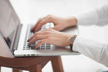 Woman working at homeoffice hand on keyboard close up