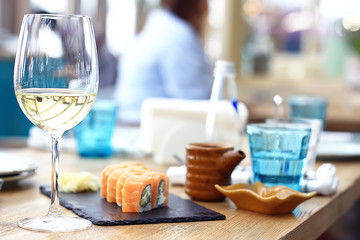 glass of white wine in the restaurant / white wine in the interior of the restaurant a table with glasses of wine, a romantic summer