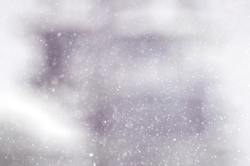 Snowfall texture of snowflakes on blurred background