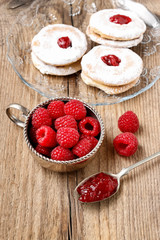 Bowl of raspberries and red jam.