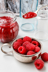 Bowl of raspberries and red jam.