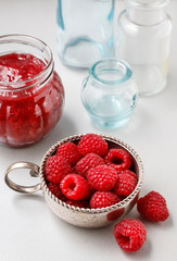 Bowl of raspberries and red jam.