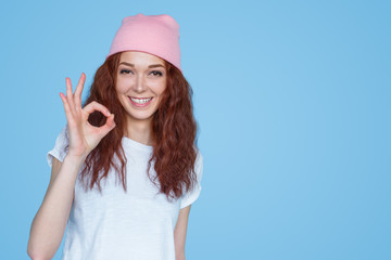 Young hipster woman showing OK sign
