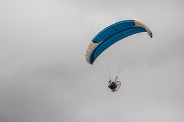 Man have fun with paraglider in a public park