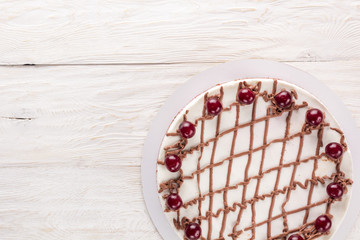 Chocolate cake with mousse, decorated cherries