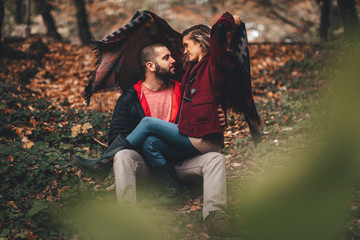 Young hipster couple in love with in the forest