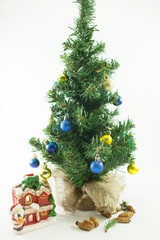 Small decorated Christmas tree. Isolated on white background. 