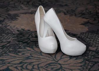 white shoes of the bride and bouquet