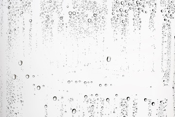 white isolated background water drops on the glass / wet window glass with splashes and drops of water and lime, texture autumn background