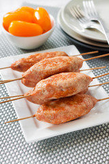 Minced turkey kebabs on square white plate