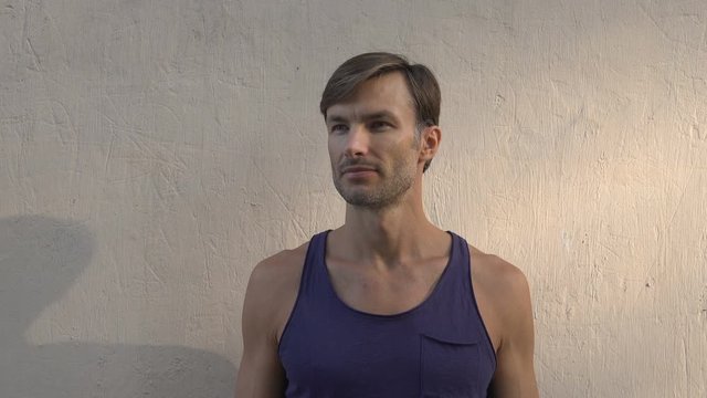 man is looking, turning his head around.