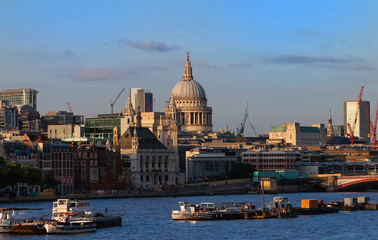 Fototapeta na wymiar The dome of St. Pauls Cathedral across the Thames river by the early evening sun, London.