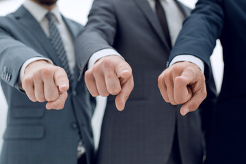 close up.three of a businessman pointing at you