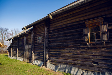 large old log house in autumn in the village standing on the lawn