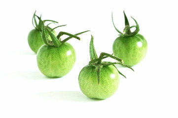 fresh green tomatoes isolated on white background