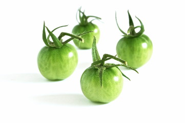 fresh green tomatoes isolated on white background