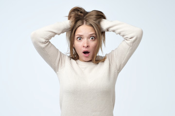 Portrait of young european woman with shocked facial expression