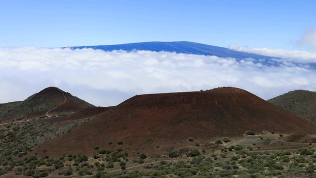 Mauna Loa volcano from Mauna Kea Hawaii above clouds fast. Mauna Kea Observatories, MKO, astronomical research facilities and large telescope. NASA and international partners.