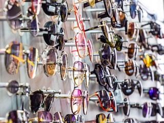 Sunglasses on the stand at the counter. Sunglasses for sale.