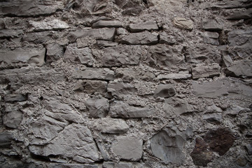 Stone wall background, horizontal wide brick wall.