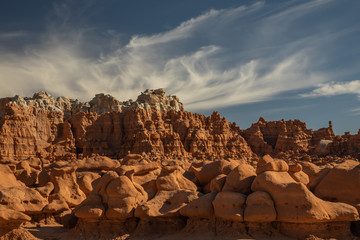 Goblin Valley Utah under white clouds in blue sky
