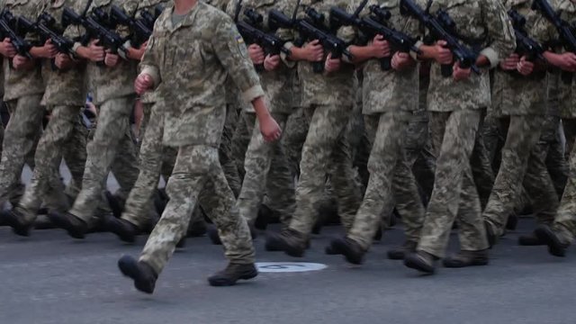 Military men marching in ranks at street