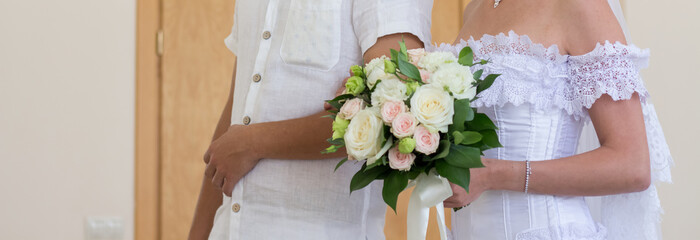 Newlyweds holding a wedding bouquet