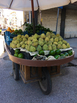 voiture &agrave; bras d'un vendeur ambulant de fruits pommes cannelle et avocats