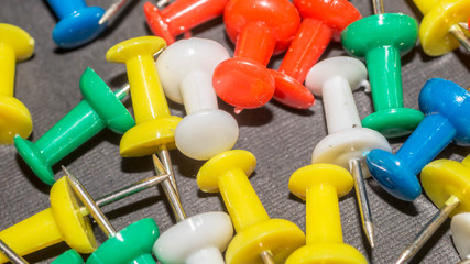 Naklejka premium colorful push pins. office and school supply background