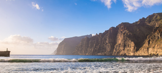 Amazing view of beach in Los Gigantes with high cliffs on the sunset. Location: Los Gigantes, Tenerife, Canary Islands. Artistic picture. Beauty world. Panorama