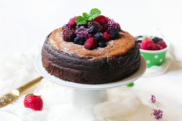 Homemade Chocolate cake topped with fresh fruits and cocoa buttercream frosting