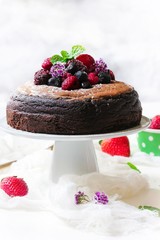 Homemade Chocolate cake topped with fresh fruits and cocoa buttercream frosting