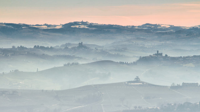 View of Langhe hills with vineyards in a foggy day from Verduno, Barolo area, Piedmont, Italy