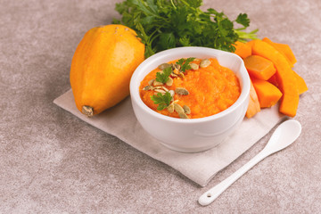 Bright tasty pureed pumpkin soup with ingredients