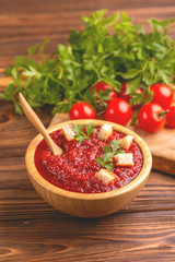 Bright fresh tasty pureed tomato soup with ingredients