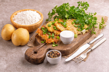 Homemade potato pancakes or latke Hanukkah celebration food with ingredients