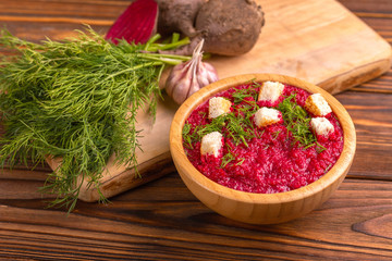 Bright tasty pureed beetroot soup with ingredients. Healthy food