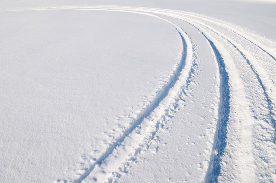 Car Tire Tracks In Fresh Snow.