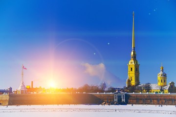 Fototapeta premium Art views of St. Petersburg. Picturesque winter landscape the Peter and Paul fortress in bright rays sun.