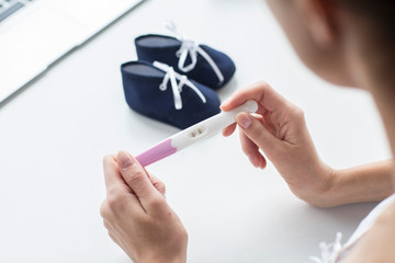 Woman holding on her hands pregnancy test.