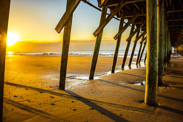 Golden sunrise from under the fishing pier