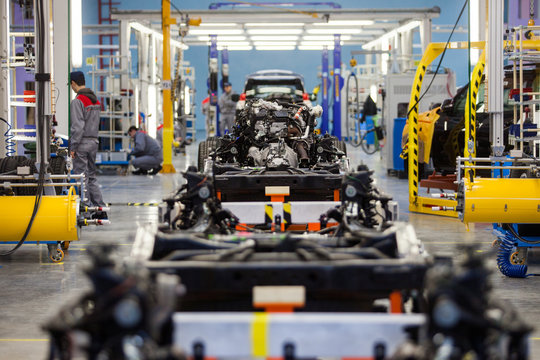 Automotive Plant. Disassembled Cars Are In A Large Bright Workshop.