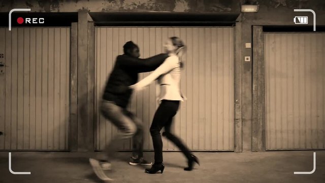 Young woman victim of an assault in the basement: the girl paractincing a self defense technique