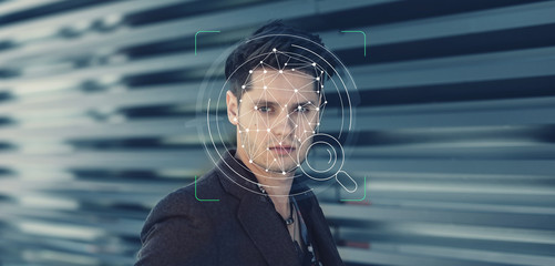 Young guy face ID technology facial recognition use in biometric security for phone or mobile...