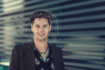 Young guy face ID technology facial recognition use in biometric security for phone or mobile...