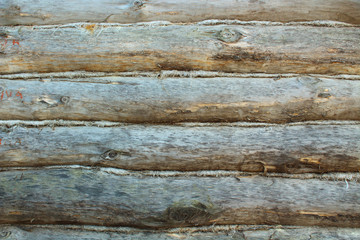 Old round wooden logs of log. Close-up. Background. Texture.