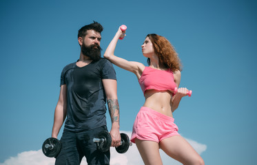 Obraz na płótnie Canvas Sporty fitness couple. Healthy lifestyle concept. Beautiful attractive fitness friends. Abs fitness woman body. Female model in sportswear exercising outdoors.