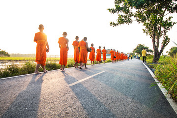 Monks and novices walk on the street.