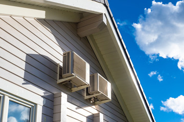 Air conditioning at home. Two air conditioners hang on the wall of the house. Ventilation of rooms.