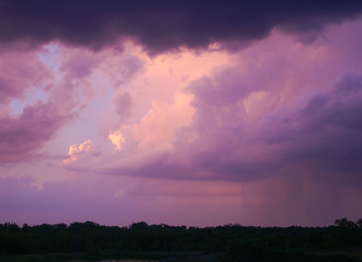Purple sky of a summer storm mixed with sunny sky at dusk in Minnesota